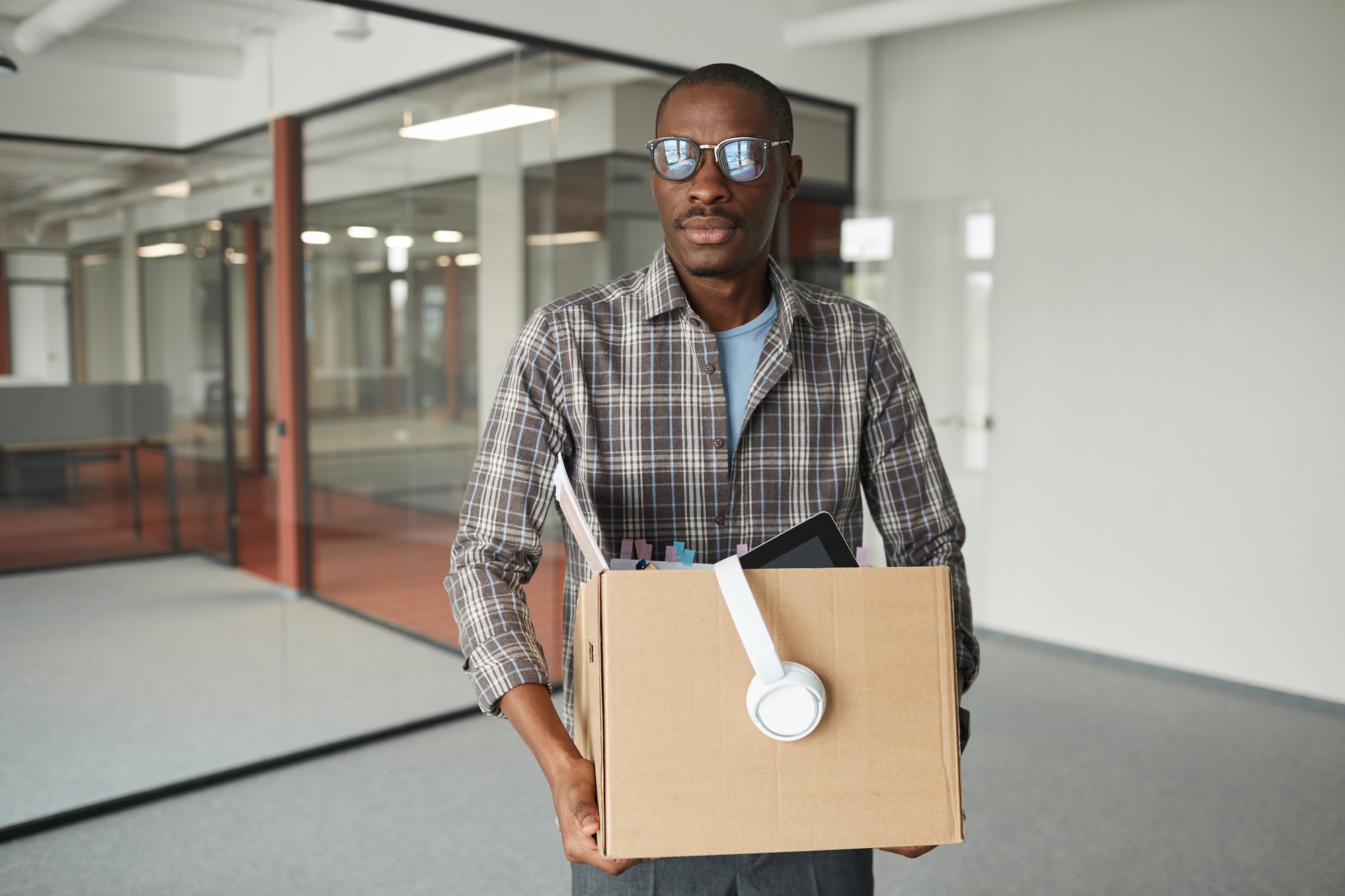 An office worker leaving with a box of belongings